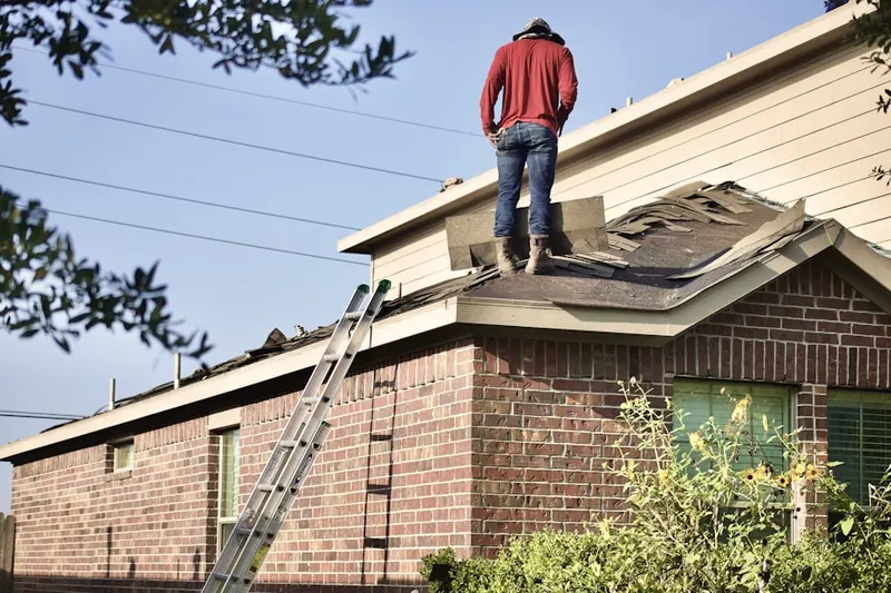 Professional roofer working on a residential roof in South Boston